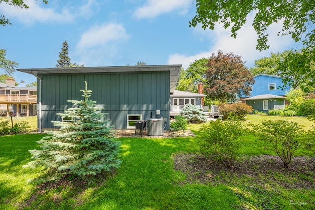1447 Hillcrest Rd, Downers Grove, IL 60516 - back of property with board and batten siding, a yard, and a wooden deck