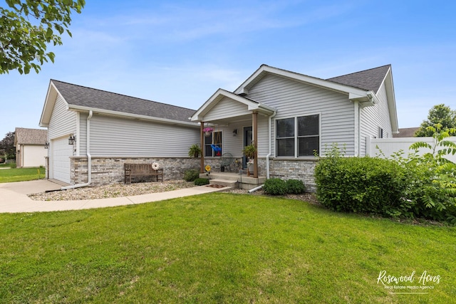 840 Peony Ln, Bourbonnais, IL 60914 - view of front of house with covered porch, an attached garage, stone siding, concrete driveway, and roof with shingles