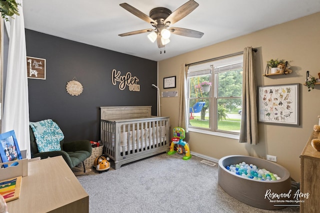 840 Peony Ln, Bourbonnais, IL 60914 - bedroom with a crib, carpet floors, and a ceiling fan