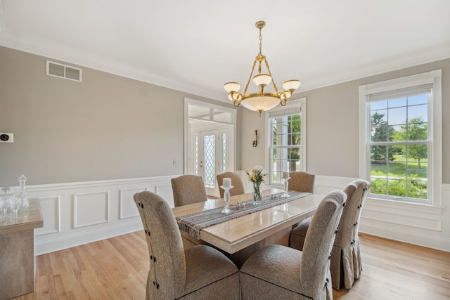 38W385 Stevens Glen Rd, Saint Charles, IL 60175 - dining space with a chandelier, light wood-style floors, ornamental molding, wainscoting, and a decorative wall