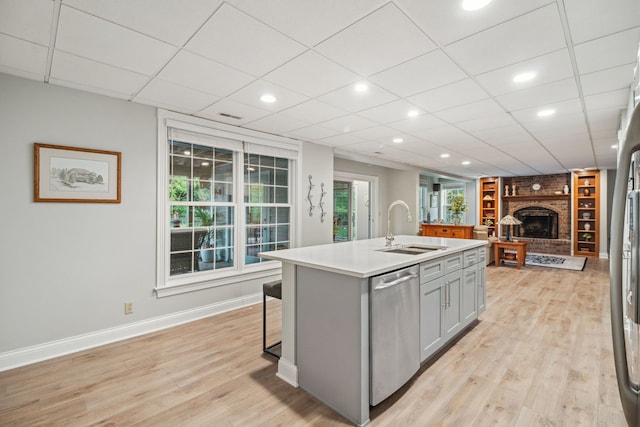 38W385 Stevens Glen Rd, Saint Charles, IL 60175 - kitchen with dishwasher, gray cabinets, a brick fireplace, open floor plan, and light wood-type flooring