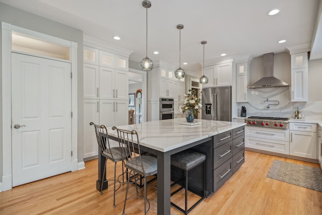 38W385 Stevens Glen Rd, Saint Charles, IL 60175 - kitchen with appliances with stainless steel finishes, wall chimney range hood, white cabinetry, a kitchen island, and tasteful backsplash