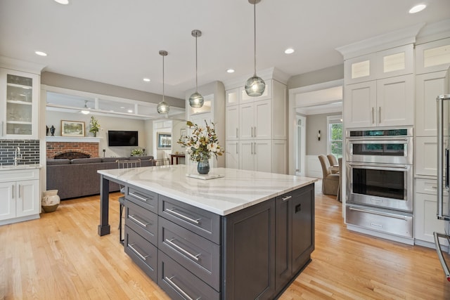 38W385 Stevens Glen Rd, Saint Charles, IL 60175 - kitchen with white cabinets, a warming drawer, stainless steel double oven, light wood-style flooring, and recessed lighting