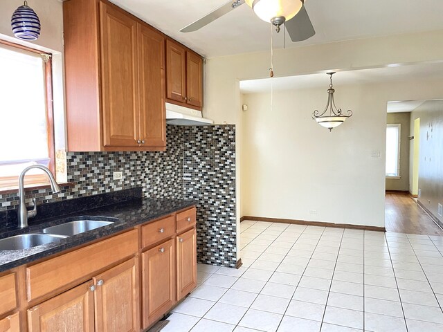 3909 W 71st St, Chicago, IL 60629 - kitchen with plenty of natural light, under cabinet range hood, decorative backsplash, and a ceiling fan
