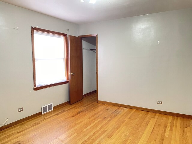 3909 W 71st St, Chicago, IL 60629 - unfurnished bedroom featuring light wood-style flooring and a closet