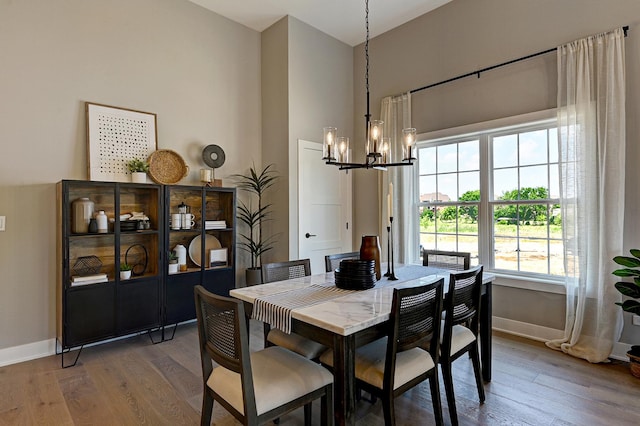 12830 Marble St Unit 25A, Lemont, IL 60439 - dining area featuring a chandelier, wood finished floors, and a towering ceiling