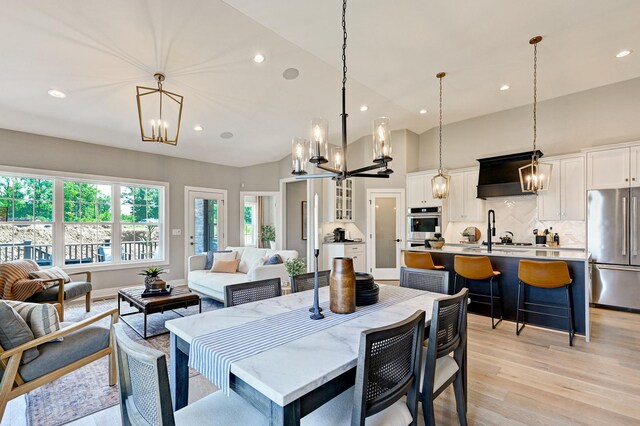 12830 Marble St Unit 25A, Lemont, IL 60439 - dining room with a chandelier, recessed lighting, light wood-style flooring, and high vaulted ceiling