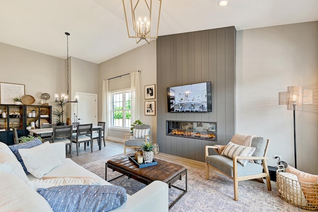 12830 Marble St Unit 25A, Lemont, IL 60439 - living area with a chandelier, light wood finished floors, a fireplace, and a towering ceiling