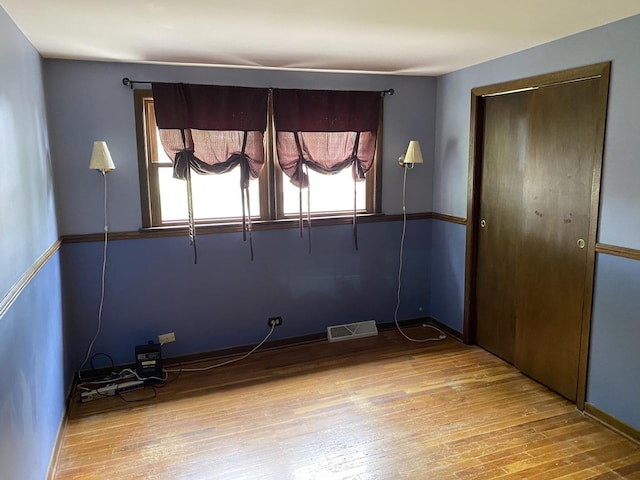 11737 S Kedvale Ave, Alsip, IL 60803 - unfurnished bedroom with multiple windows, hardwood / wood-style flooring, and a closet