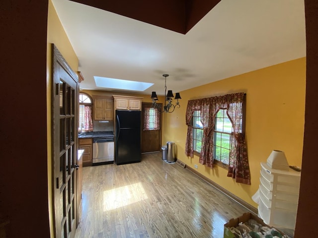 11737 S Kedvale Ave, Alsip, IL 60803 - kitchen featuring freestanding refrigerator, dishwasher, a chandelier, light wood finished floors, and healthy amount of natural light