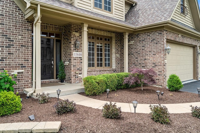 11646 Liberty Ln, Plainfield, IL 60585 - property entrance featuring brick siding, roof with shingles, an attached garage, and driveway