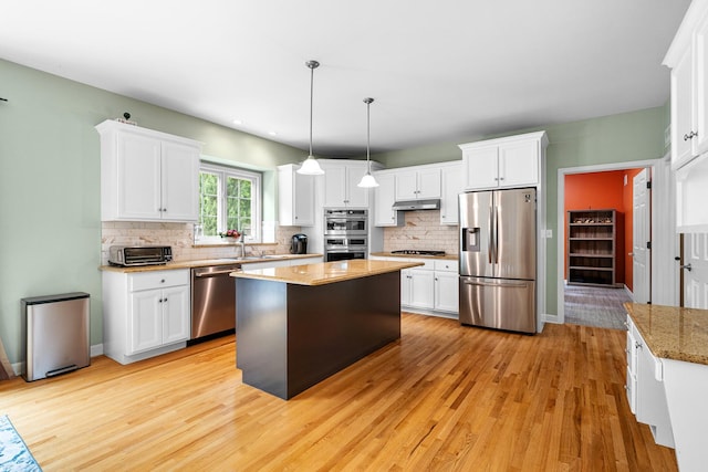 11646 Liberty Ln, Plainfield, IL 60585 - kitchen featuring stainless steel appliances, under cabinet range hood, light wood-style floors, white cabinets, and recessed lighting