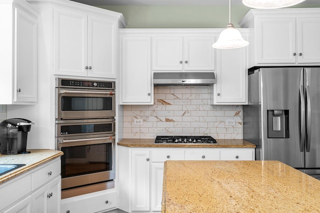 11646 Liberty Ln, Plainfield, IL 60585 - kitchen featuring appliances with stainless steel finishes, white cabinets, light stone counters, and tasteful backsplash