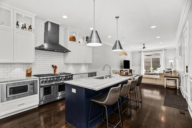 2769 N Kenmore Ave Unit 1, Chicago, IL 60614 - kitchen featuring wall chimney exhaust hood, appliances with stainless steel finishes, crown molding, dark wood-type flooring, and open floor plan
