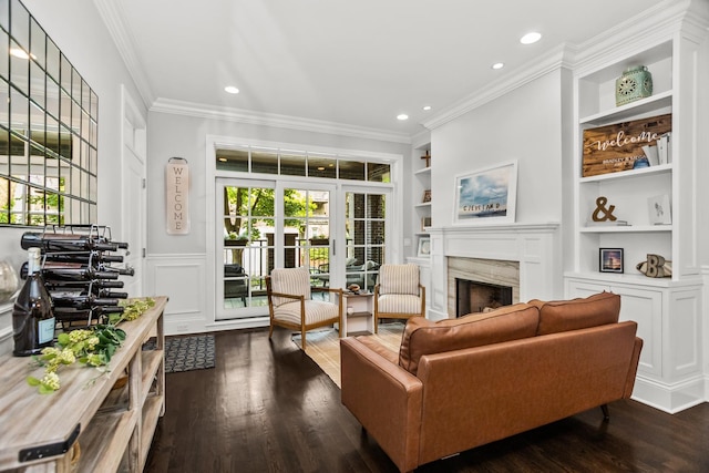 2769 N Kenmore Ave Unit 1, Chicago, IL 60614 - living room featuring a premium fireplace, healthy amount of natural light, dark wood-type flooring, built in shelves, and crown molding