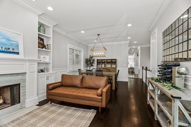 2769 N Kenmore Ave Unit 1, Chicago, IL 60614 - living area with a high end fireplace, a decorative wall, recessed lighting, wood finished floors, and a wainscoted wall