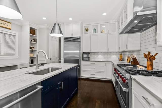 2769 N Kenmore Ave Unit 1, Chicago, IL 60614 - kitchen featuring high quality appliances, wall chimney range hood, white cabinets, dark wood-style flooring, and crown molding
