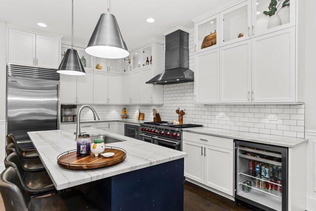 2769 N Kenmore Ave Unit 1, Chicago, IL 60614 - kitchen featuring wall chimney exhaust hood, beverage cooler, high end appliances, light stone countertops, and recessed lighting