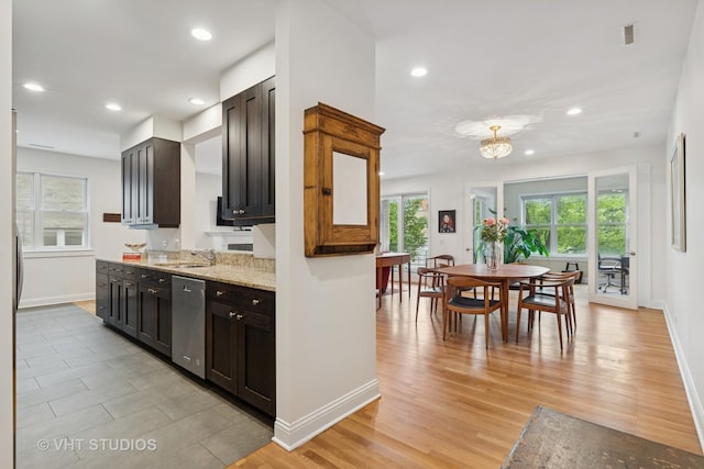 2835 N Lakewood Ave Unit 2C, Chicago, IL 60657 - kitchen featuring dishwasher, recessed lighting, light wood-style floors, light stone counters, and a chandelier