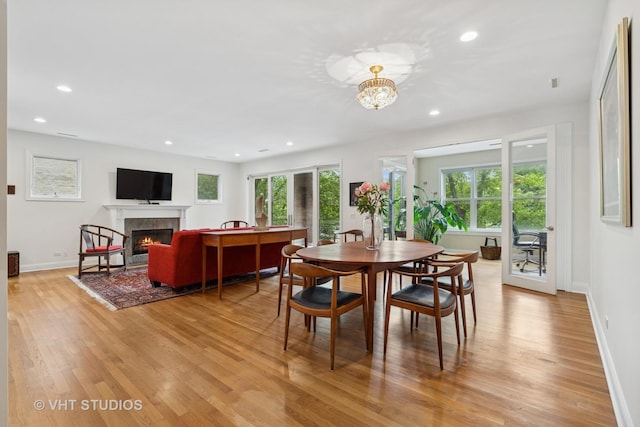 2835 N Lakewood Ave Unit 2C, Chicago, IL 60657 - dining area with light wood finished floors, recessed lighting, a warm lit fireplace, and a chandelier