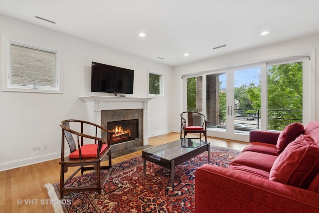 2835 N Lakewood Ave Unit 2C, Chicago, IL 60657 - living room with a tiled fireplace, plenty of natural light, wood finished floors, and recessed lighting