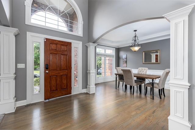 5327 Bamboo Ln, Naperville, IL 60564 - foyer entrance with decorative columns, wood finished floors, plenty of natural light, arched walkways, and ornamental molding