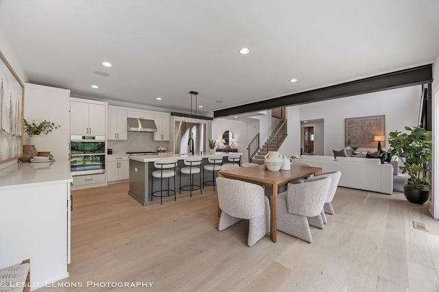 20 Pinnacle Ct, Naperville, IL 60565 - dining room with light wood-style flooring, stairway, and recessed lighting