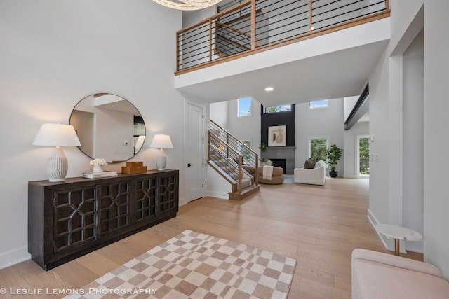 20 Pinnacle Ct, Naperville, IL 60565 - foyer featuring a towering ceiling, stairs, wood finished floors, and a large fireplace