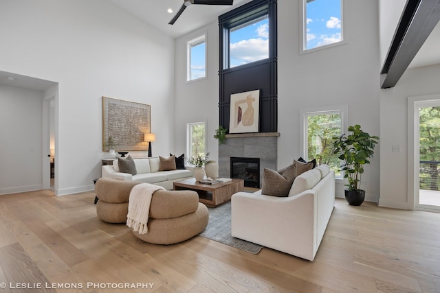 20 Pinnacle Ct, Naperville, IL 60565 - living room featuring high vaulted ceiling, light wood finished floors, a glass covered fireplace, and ceiling fan