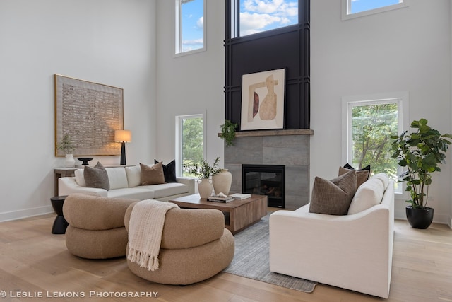 20 Pinnacle Ct, Naperville, IL 60565 - living area featuring a high ceiling, healthy amount of natural light, a tile fireplace, and light wood finished floors