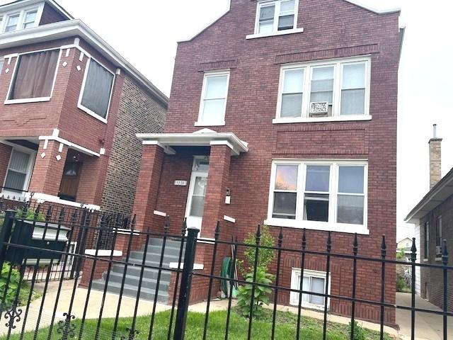 5536 S Albany Ave, Chicago, IL 60629 - view of front of house with brick siding and a fenced front yard