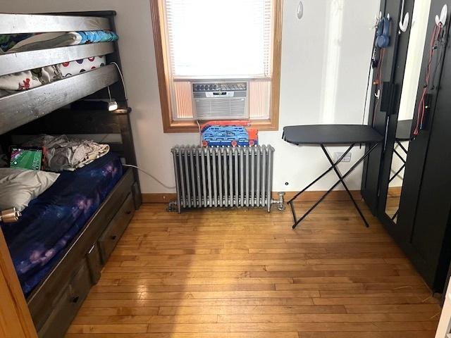 5536 S Albany Ave, Chicago, IL 60629 - bedroom featuring radiator, wood-type flooring, and cooling unit