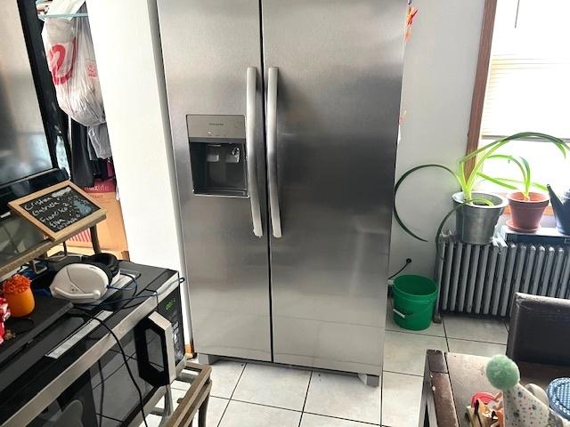 5536 S Albany Ave, Chicago, IL 60629 - kitchen with stainless steel fridge with ice dispenser, light tile patterned flooring, and radiator