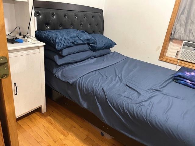 5536 S Albany Ave, Chicago, IL 60629 - bedroom with light wood finished floors and cooling unit