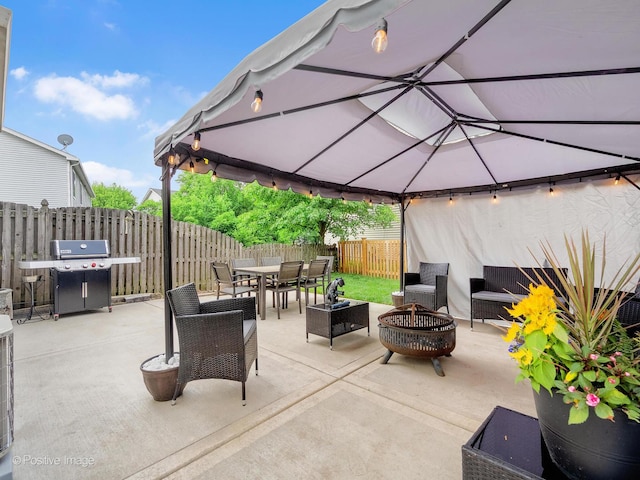 308 Ramsey Dr, Romeoville, IL 60446 - fenced backyard with a gazebo, outdoor dining space, a patio area, an outdoor living space with a fire pit, and grilling area