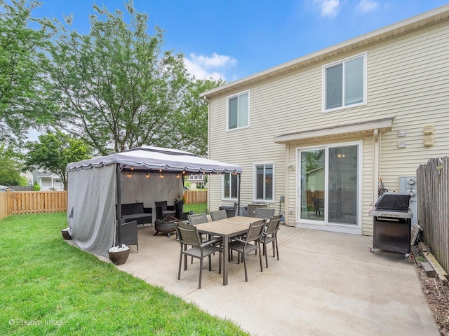 308 Ramsey Dr, Romeoville, IL 60446 - fenced backyard featuring a grill, a gazebo, a patio area, and an outdoor fire pit