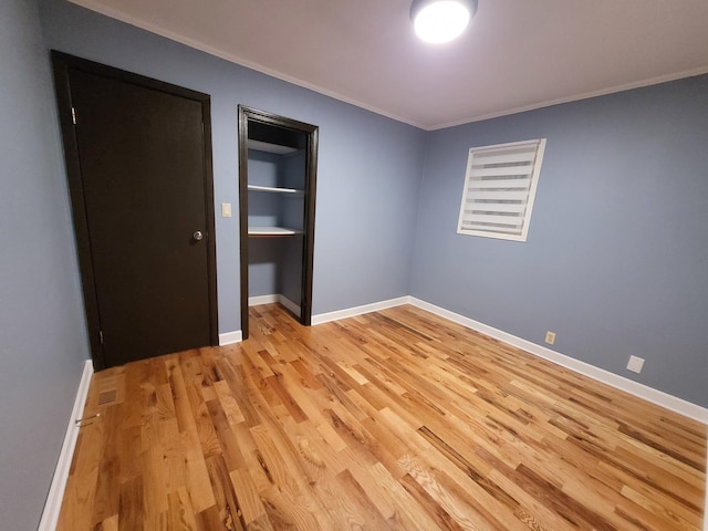 36441 N James Ct, Lake Villa, IL 60046 - unfurnished bedroom with light wood-style flooring and crown molding
