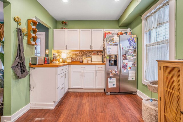 4025 W 24th St, Chicago, IL 60623 - kitchen featuring stainless steel fridge with ice dispenser, dark wood-style flooring, white cabinetry, backsplash, and butcher block counters