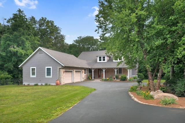 2 Timber Ridge Ln, Mansfield, IL 61854 - view of front of house with a garage, driveway, a front lawn, and covered porch