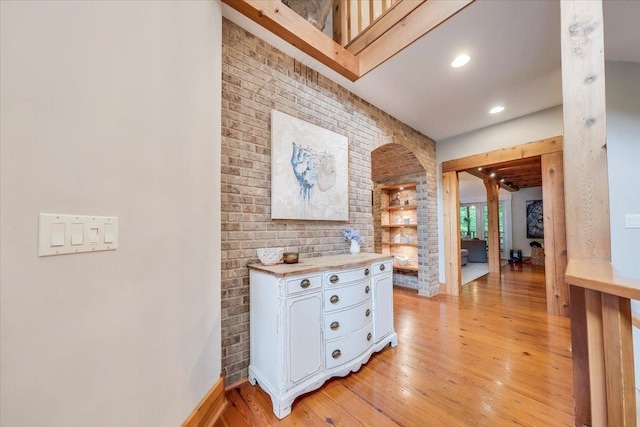 2 Timber Ridge Ln, Mansfield, IL 61854 - hallway featuring light wood-style floors, brick wall, and recessed lighting
