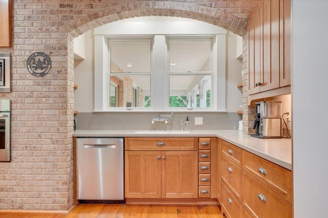 2 Timber Ridge Ln, Mansfield, IL 61854 - kitchen with appliances with stainless steel finishes, arched walkways, light countertops, and light wood-style floors