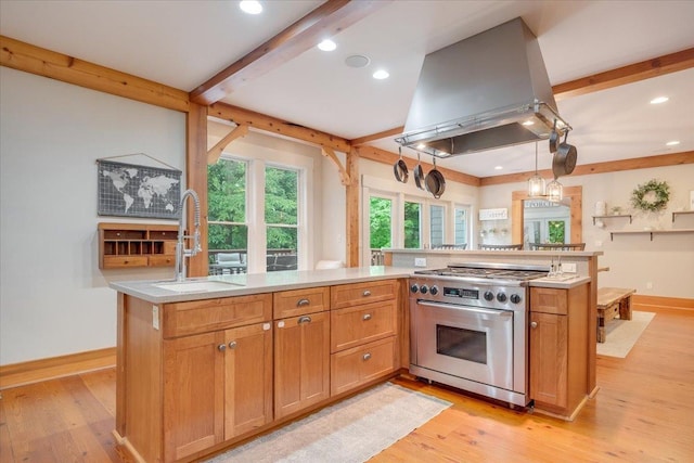 2 Timber Ridge Ln, Mansfield, IL 61854 - kitchen with stainless steel stove, wall chimney range hood, beam ceiling, light wood-type flooring, and light countertops