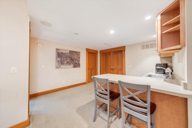 2 Timber Ridge Ln, Mansfield, IL 61854 - kitchen with a peninsula, light countertops, light carpet, a breakfast bar area, and recessed lighting