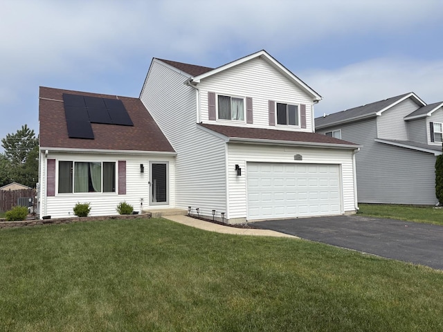 2109 Gray Hawk Dr, Plainfield, IL 60586 - view of front of property with asphalt driveway, roof mounted solar panels, an attached garage, a front yard, and a shingled roof