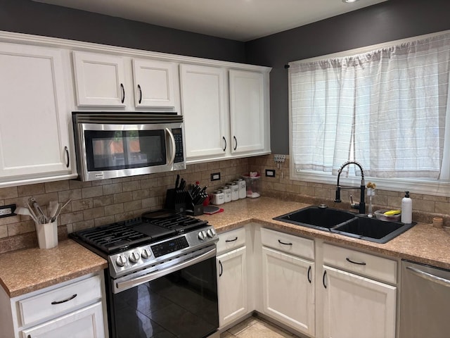 2109 Gray Hawk Dr, Plainfield, IL 60586 - kitchen with appliances with stainless steel finishes, backsplash, white cabinets, and light countertops