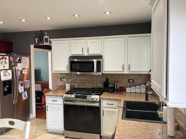 2109 Gray Hawk Dr, Plainfield, IL 60586 - kitchen with appliances with stainless steel finishes, light countertops, white cabinets, decorative backsplash, and recessed lighting