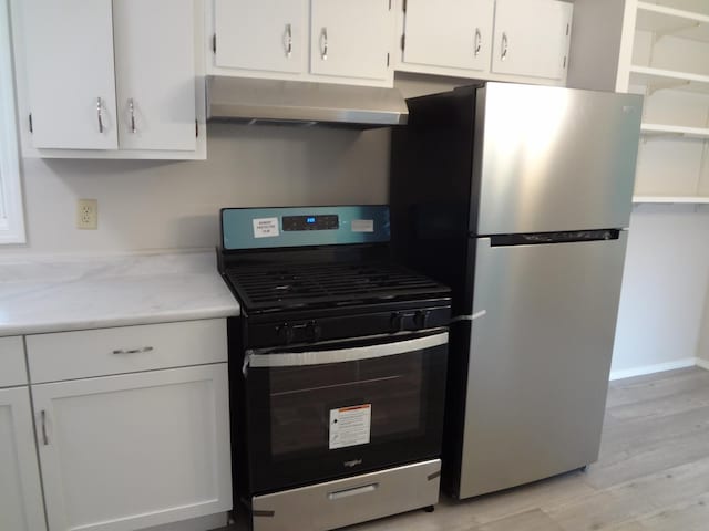 9802 Gallek Rd, Fox River Grove, IL 60021 - kitchen with stainless steel appliances, under cabinet range hood, light wood-style floors, and white cabinets