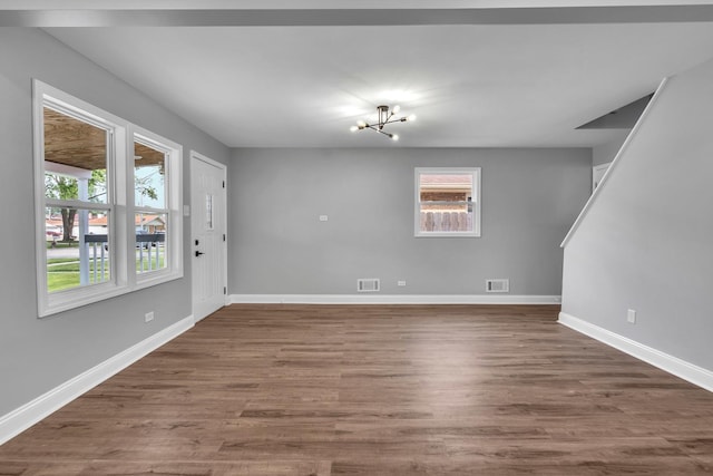 5707 W 82nd Pl, Burbank, IL 60459 - unfurnished living room featuring a chandelier and wood finished floors