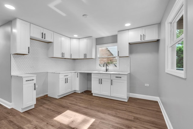 5707 W 82nd Pl, Burbank, IL 60459 - kitchen with white cabinetry, backsplash, wood finished floors, light countertops, and recessed lighting