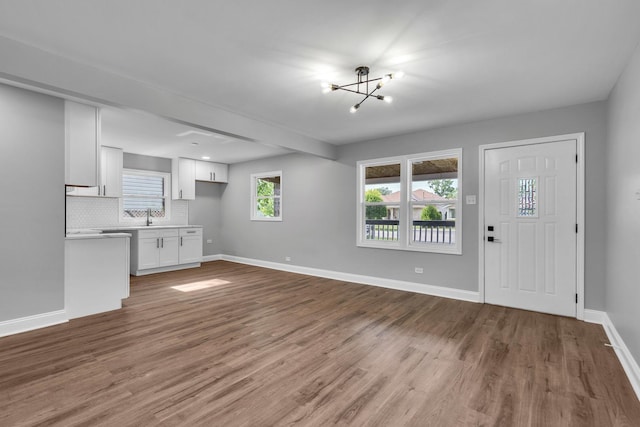 5707 W 82nd Pl, Burbank, IL 60459 - unfurnished living room featuring a chandelier and wood finished floors